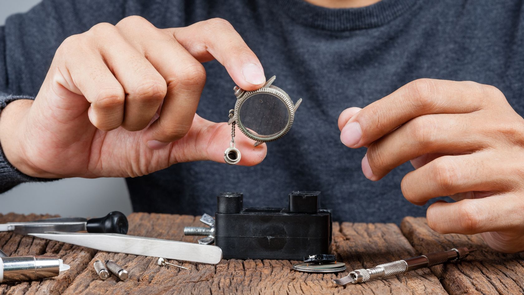 A man holding a piece of metal in his hands