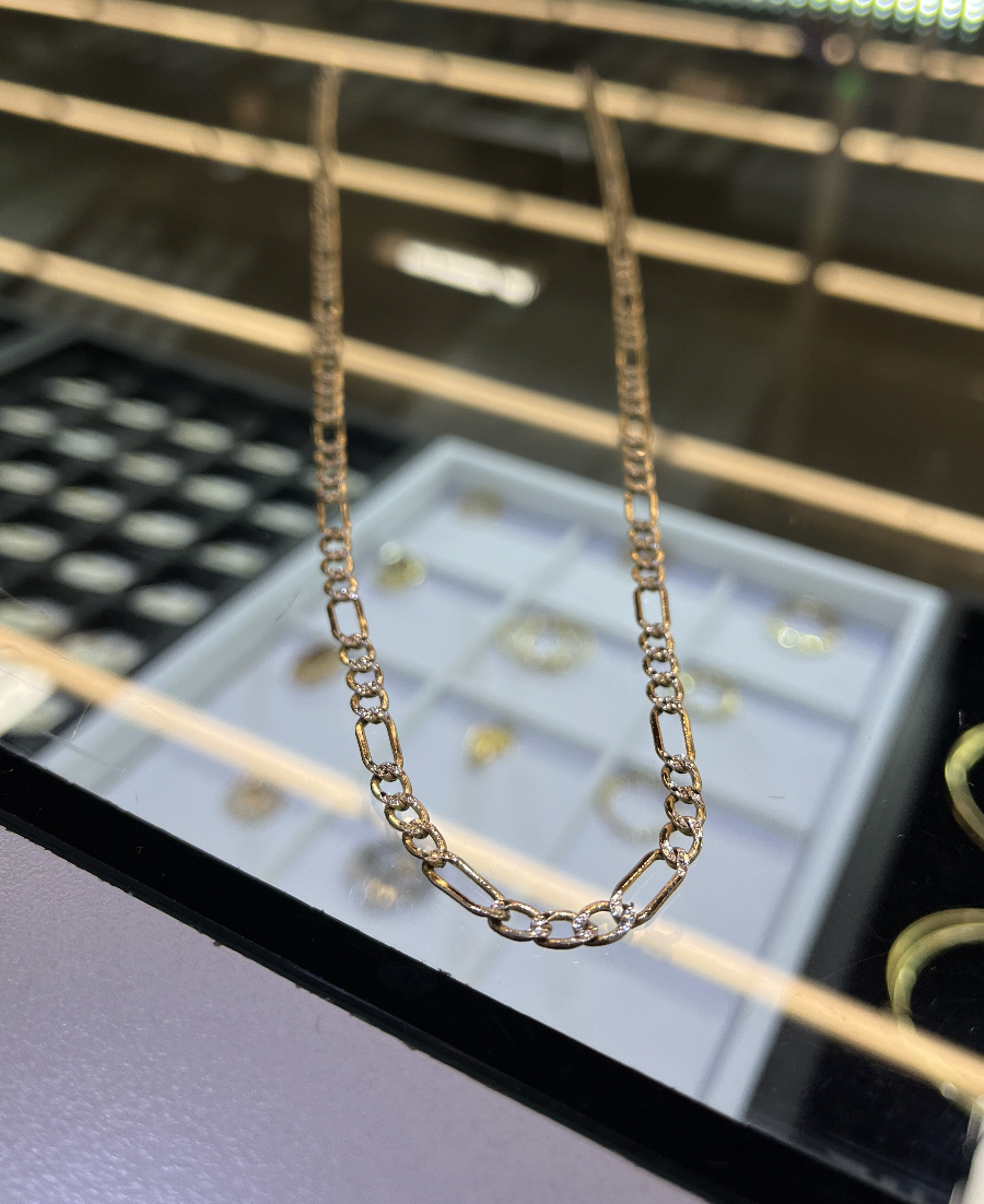 A gold chain on display in a jewelry store