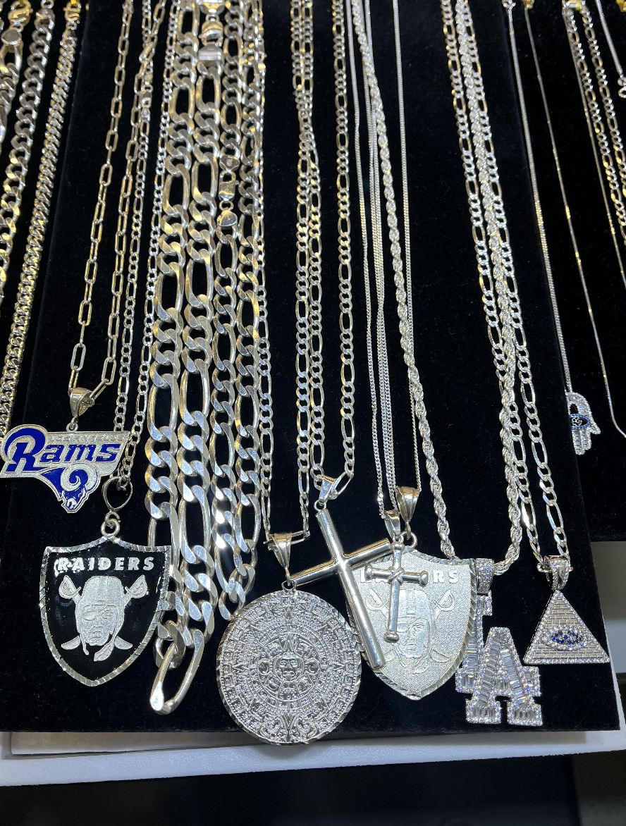 A bunch of necklaces that are on a shelf